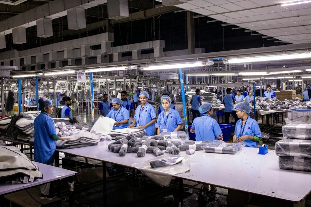 Indian textile factory workers expertly packaging products on an assembly line.